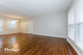 Belton house for rent - A room with wooden floors and white walls, with a window on the right side.