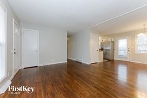Belton house for rent - A spacious empty room with wooden floors and white walls.