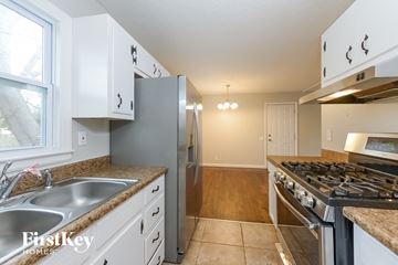 Belton house for rent - A kitchen with white cabinets and a stainless steel refrigerator.