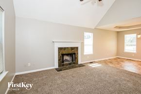 Adairsville house for rent - the living room has a fireplace and carpeted flooring