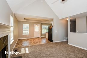 Adairsville house for rent - the living room of an empty house with a fireplace