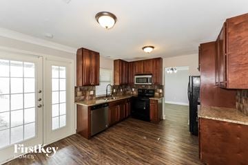 Mesquite house for rent - A kitchen with wooden cabinets and a stainless steel dishwasher.