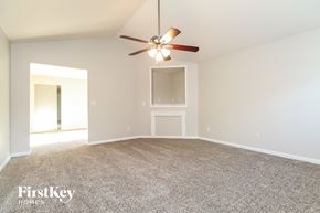 Mcdonough house for rent - A room with a ceiling fan and a carpeted floor.