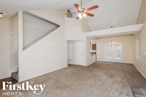 Keller house for rent - A spacious living room with a ceiling fan and a carpeted floor.