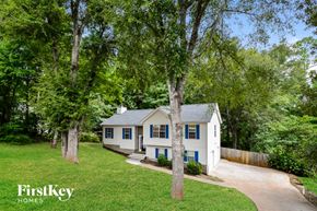 Douglasville house for rent - a white house with blue shutters and trees