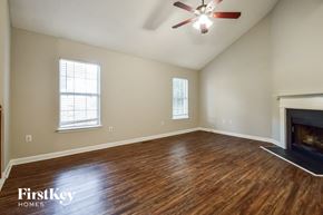 Douglasville house for rent - the living room with wood flooring and a fireplace