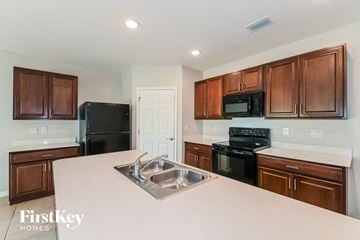Cape Coral house for rent - A kitchen with brown cabinets and a white counter top.
