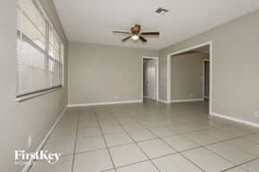 Greenacres house for rent - A spacious room with a ceiling fan and tiled flooring.