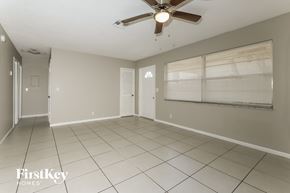 Greenacres house for rent - A spacious room with a ceiling fan and tiled flooring.