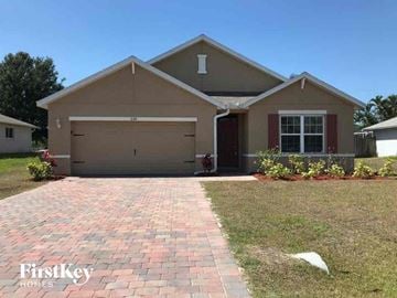 Cape Coral house for rent - a house with a driveway and a garage door