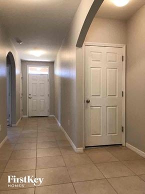 Cape Coral house for rent - a hallway with two white doors and a tiled floor