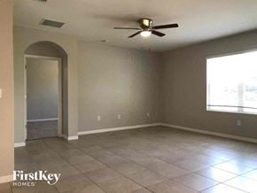 Cape Coral house for rent - an empty living room with a ceiling fan