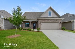 Calera house for rent - a home with a garage door and a lawn