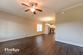 Calera house for rent - the living room of an empty house with a ceiling fan