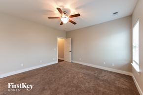 Calera house for rent - the master bedroom has a carpeted floor and a ceiling fan