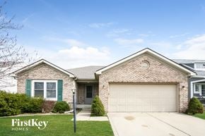 Greenwood house for rent - A house with a garage door and a sign that says "FirstKey Homes".