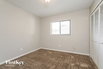 Cape Coral house for rent - a spacious living room with carpet and a window