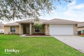Davenport house for rent - a beige house with a lawn and a white garage door