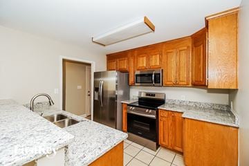 Concord house for rent - A kitchen with wooden cabinets and granite countertops.