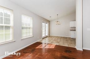 Powder Springs house for rent - A room with wooden floors and a chandelier.