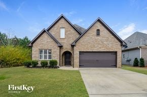 Odenville house for rent - a large brick house with a brown garage door