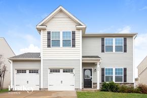 Troutman house for rent - a white house with two white garage doors