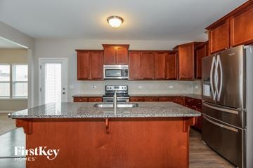Troutman house for rent - full view of kitchen with granite counter tops and wooden cabinets