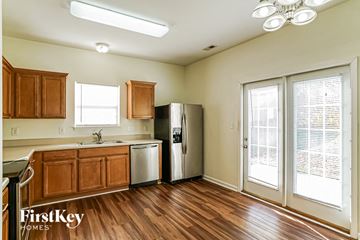 Fuquay Varina house for rent - A kitchen with wooden cabinets and a refrigerator.