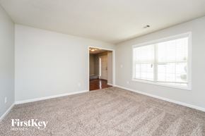 Covington house for rent - A spacious room with a carpeted floor and a doorway leading to another room.