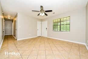 Covington house for rent - A spacious room with a ceiling fan and a window.