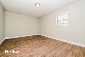 Covington house for rent - A room with wooden flooring and a window with blinds.