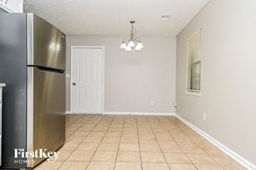Covington house for rent - A kitchen with a stainless steel refrigerator and a tile floor.