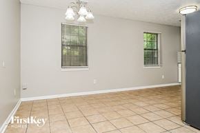 Covington house for rent - A room with a tile floor and a window with blinds.