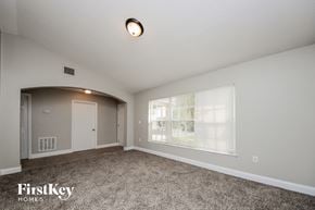 Kissimmee house for rent - the living room of an empty house with a large window