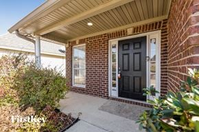 Birmingham house for rent - the front porch of a brick house with a black door