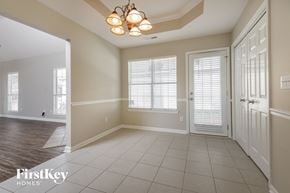 Birmingham house for rent - an empty dining room with a white door and a chandelier
