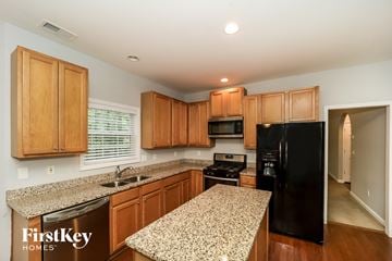 Acworth house for rent - A kitchen with wooden cabinets and a granite countertop.