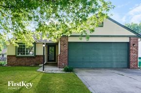 Avon house for rent - A house with a garage door and a sign that says "FirstKey Homes".