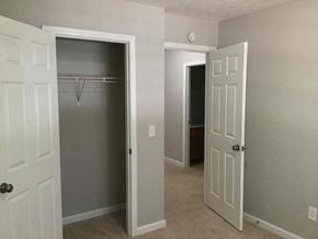 Covington house for rent - a bedroom with a closet and an open door to a closet
