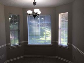 Covington house for rent - a dining room with three windows and a chandelier