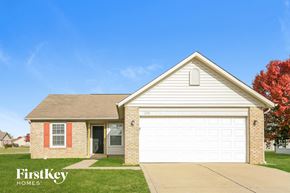 Greenfield house for rent - A house with a garage door and a sign that says FirstKey Homes.
