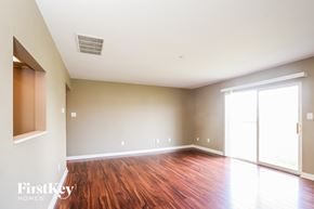 Greenfield house for rent - A room with wooden floors and a sliding glass door.