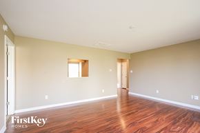 Greenfield house for rent - A room with wooden floors and a window is empty and waiting to be furnished.