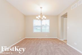 Lindenhurst house for rent - a spacious dining room with carpet and a chandelier