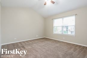 Lindenhurst house for rent - a bedroom with a carpeted floor and a window