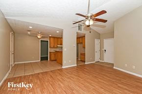 Covington house for rent - an empty living room with a ceiling fan and wood floors