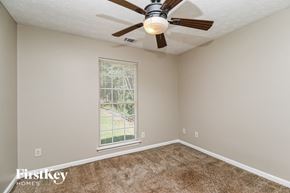 Covington house for rent - a bedroom with a ceiling fan and a window