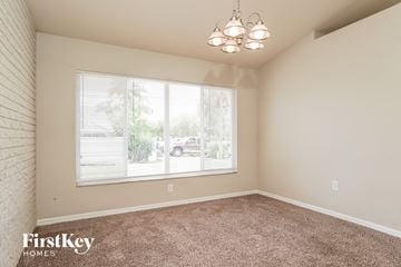 Cape Coral house for rent - the living room of a home with carpet and a large window