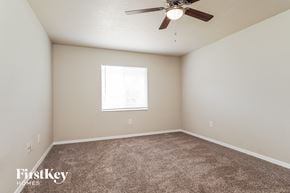 Cape Coral house for rent - a bedroom with carpet and a ceiling fan