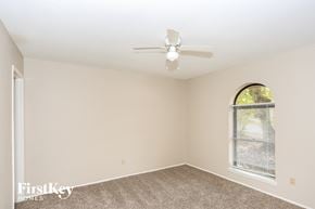 Garland house for rent - a bedroom with a ceiling fan and a window